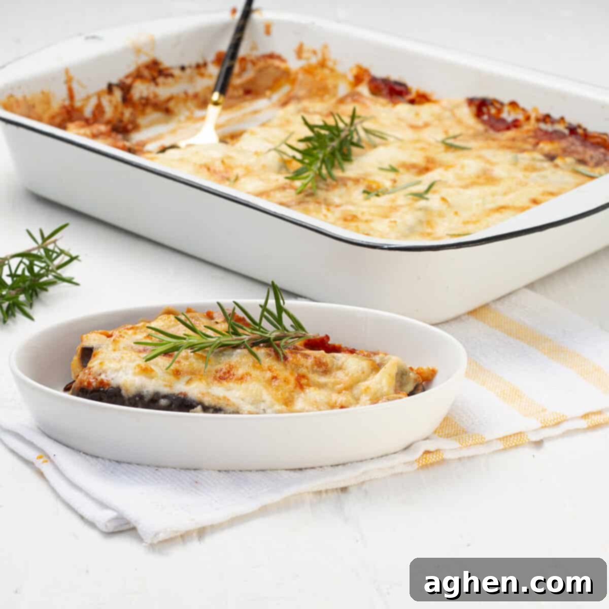 Eggplant Parmesan served in plate and baking tray