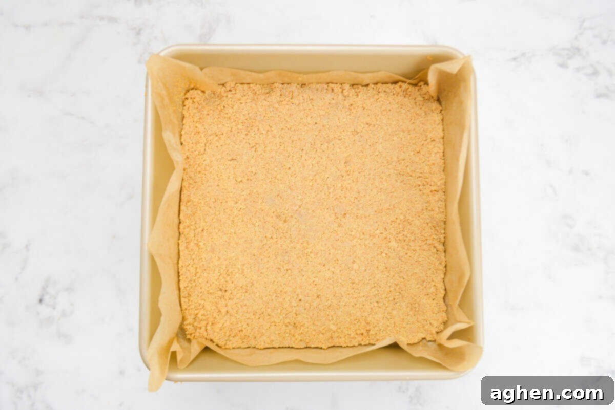 A gold square baking dish with the baked firm crust