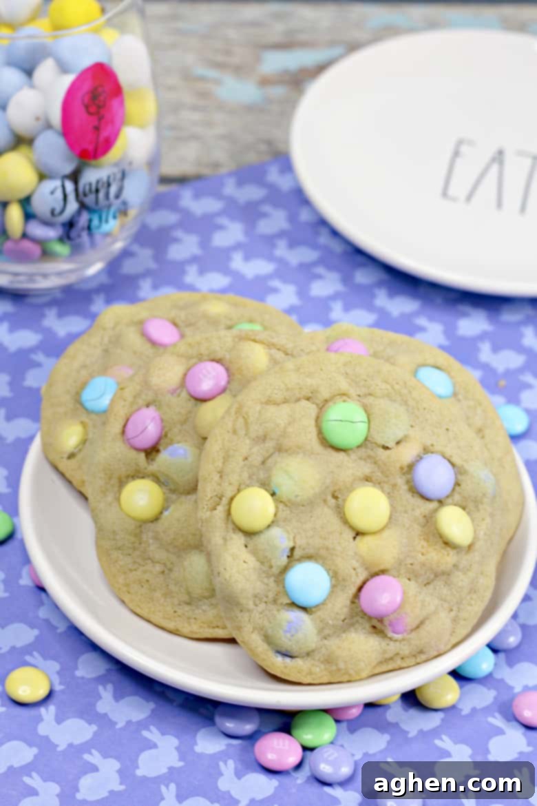 Easter cookies with pastel M&Ms, served on a white plate.