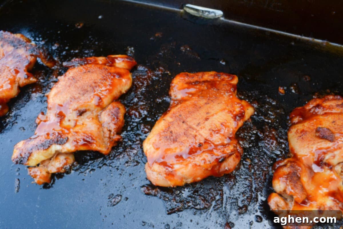 BBQ Blackstone Chicken thighs finished cooking sit on top of the Blackstone 