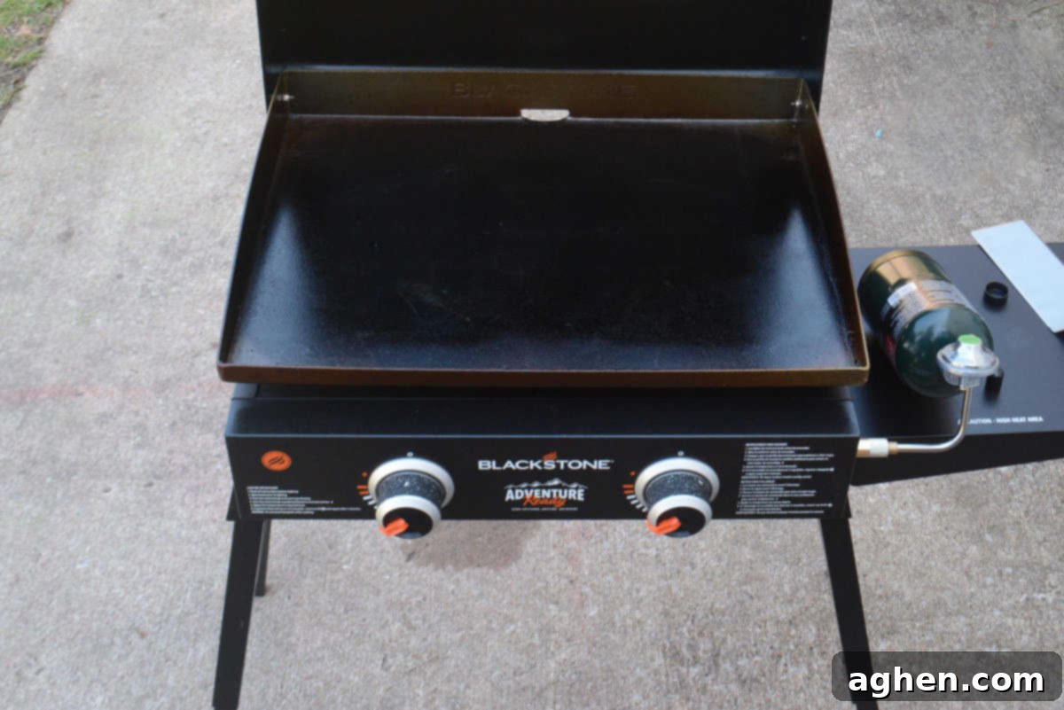 A Blackstone grill sits on a patio preheating