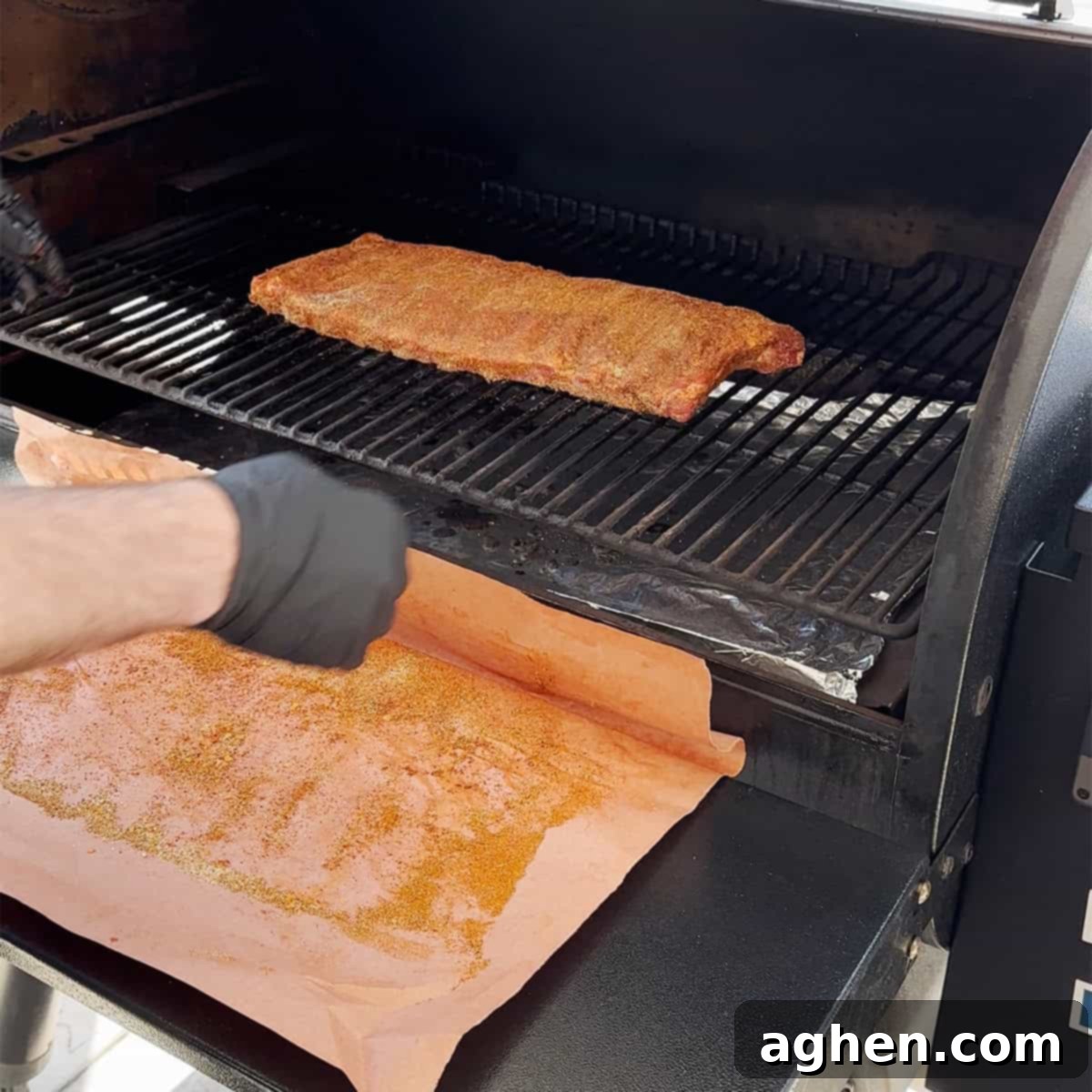 Perfect Traeger Fall Off The Bone Ribs 4 Pork ribs smoking unwrapped on a Traeger grill, being spritzed with apple cider vinegar.