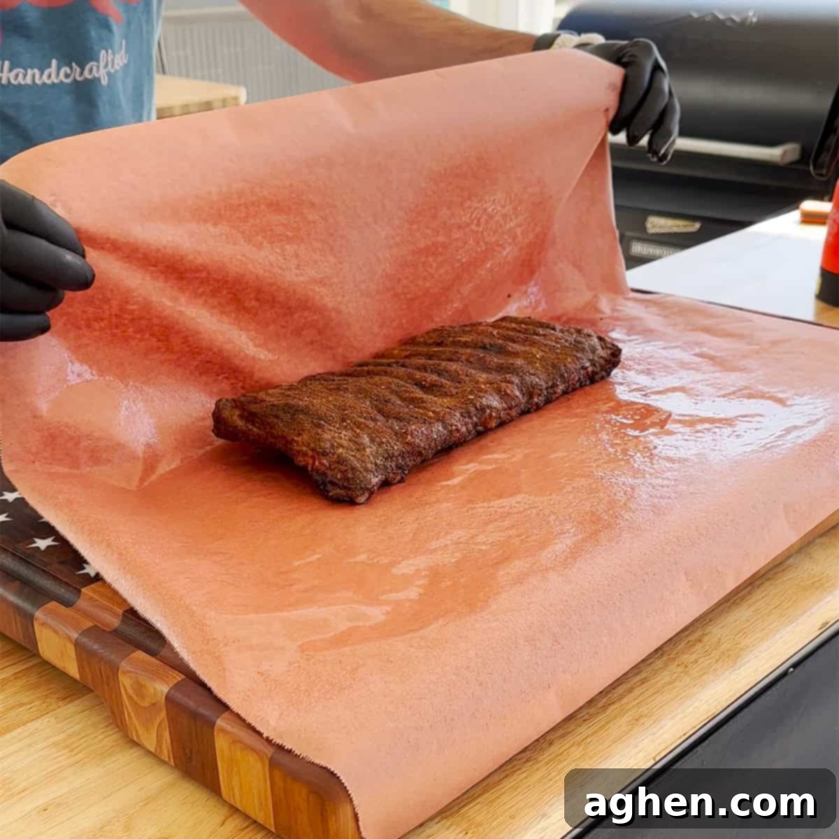 Perfect Traeger Fall Off The Bone Ribs 5 Wrapped pork ribs in butcher paper on a Traeger grill for the second stage of smoking.