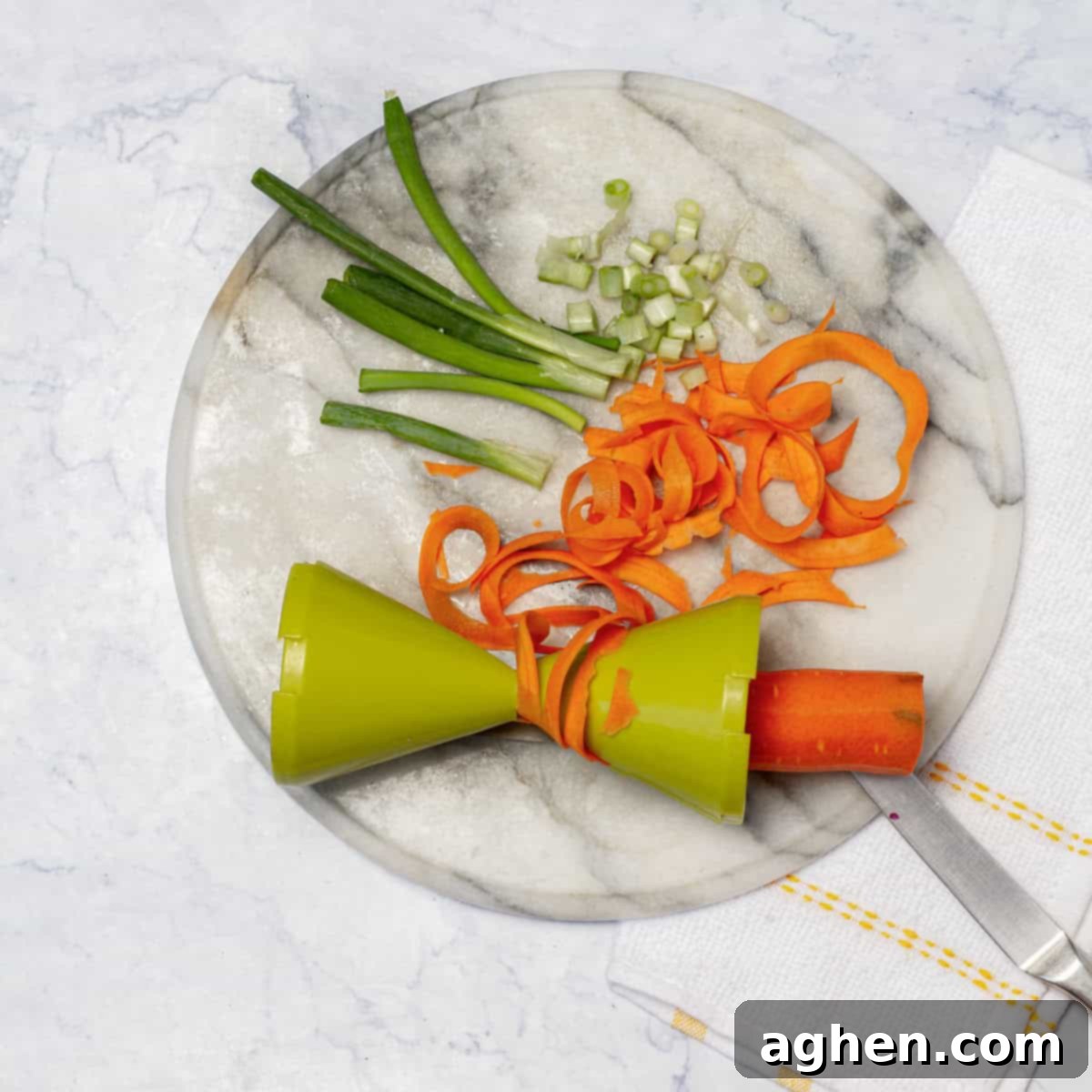 Finely sliced spring onion and julienned carrots, neatly prepared.