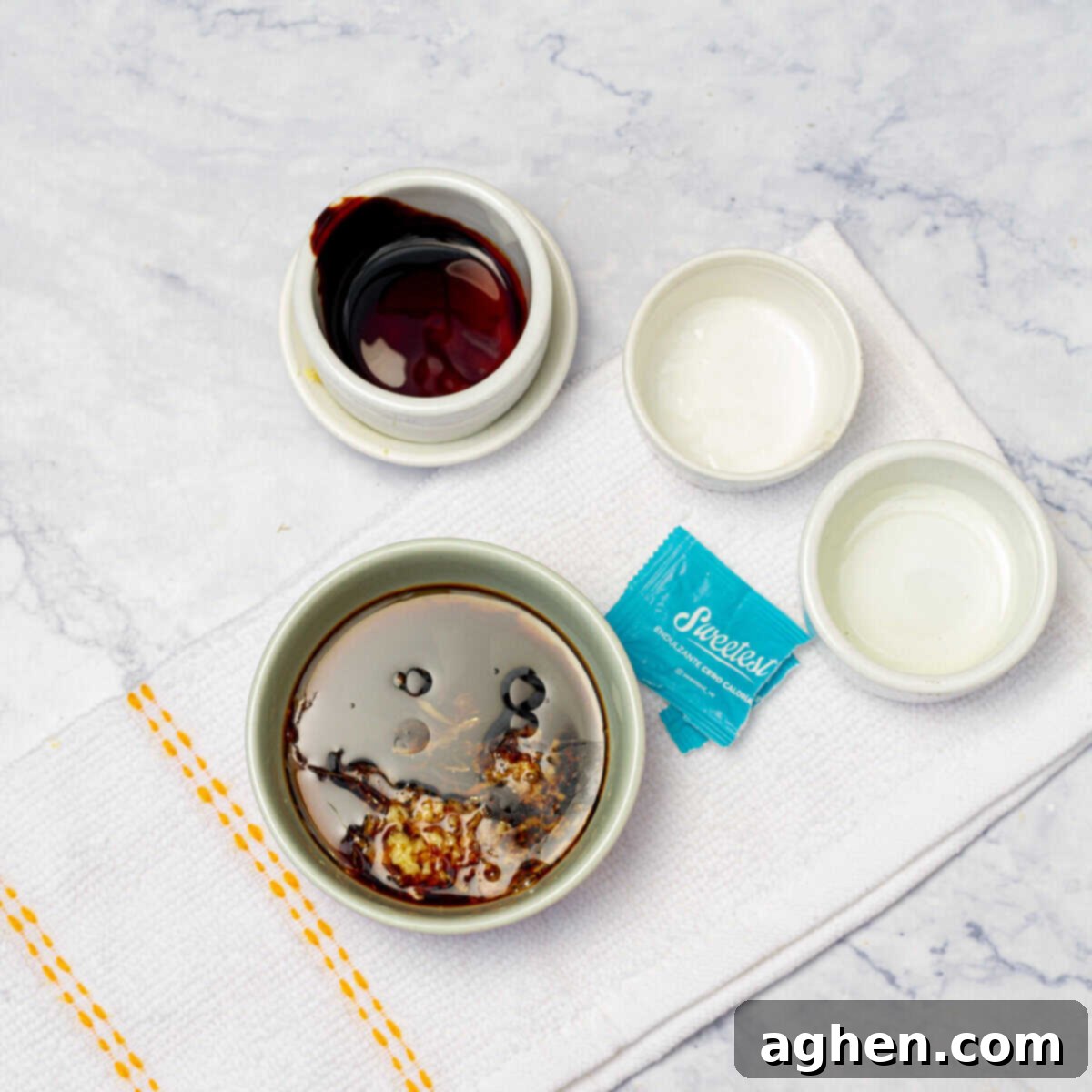 Small bowls containing the ingredients for the salad dressing: soy sauce, sesame oil, ginger, rice vinegar, garlic, and stevia.
