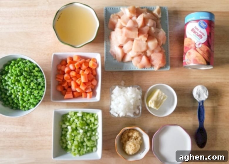 Chicken and dumpling in the Instant Pot ingredients: boneless chicken breasts, canned biscuits, olive oil, butter, garlic, onion, celery, carrots, frozen peas, heavy cream, chicken broth, cream of chicken soup, and poultry seasoning.