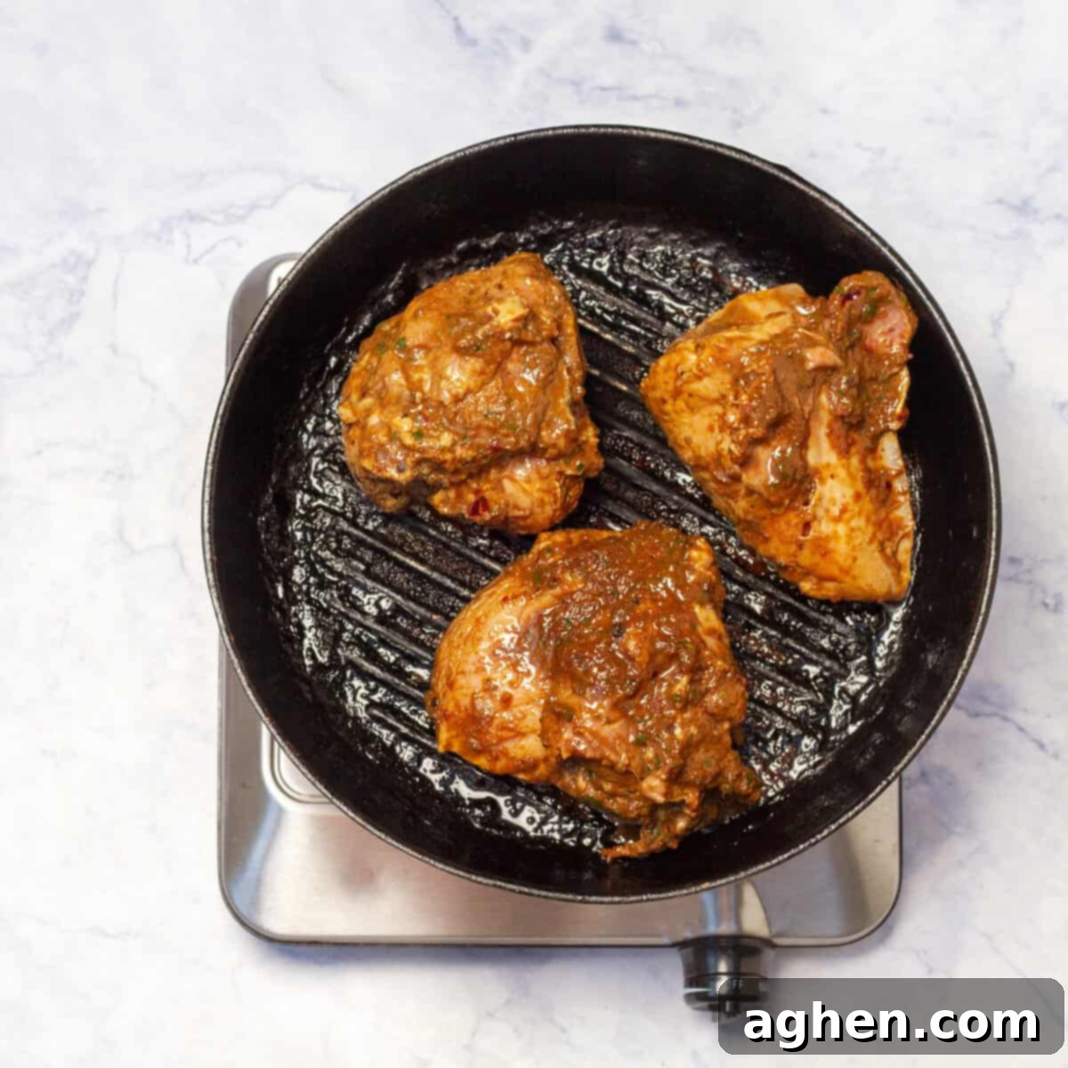 Grill the Jerk Chicken on a hot skillet until charred and cooked through