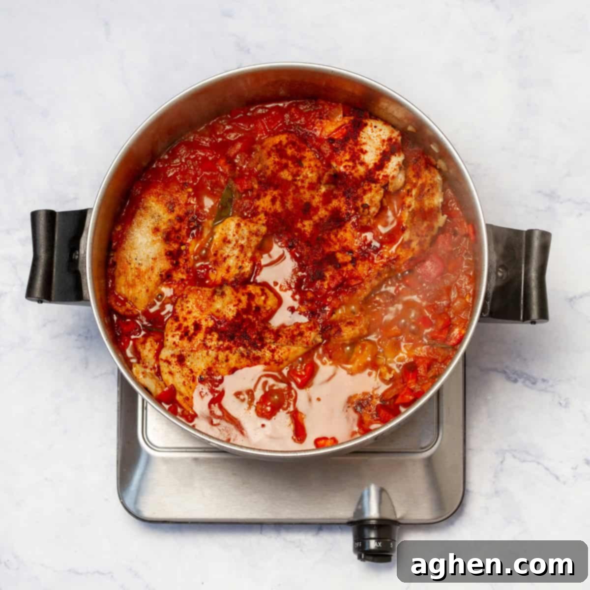 Velvety Chicken Paprikash 7 Deglazing the pan with chicken broth after cooking vegetables and spices