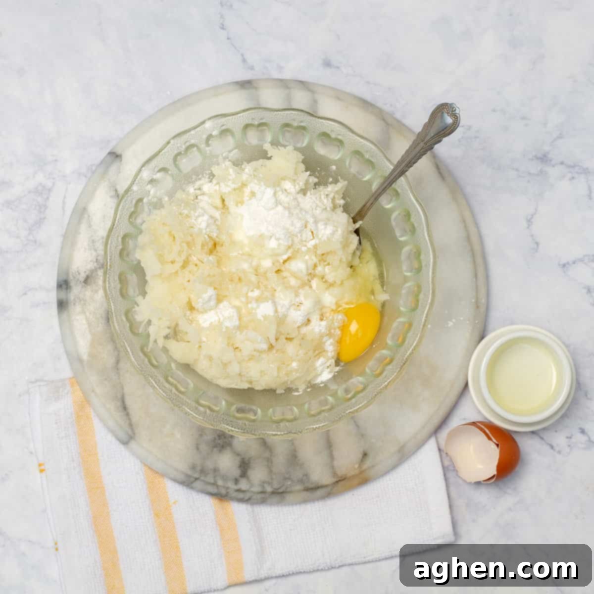 Golden Yucca Delights 6 A mixing bowl with the grated cooked yuca, egg, cassava flour, cottage cheese, and salt
