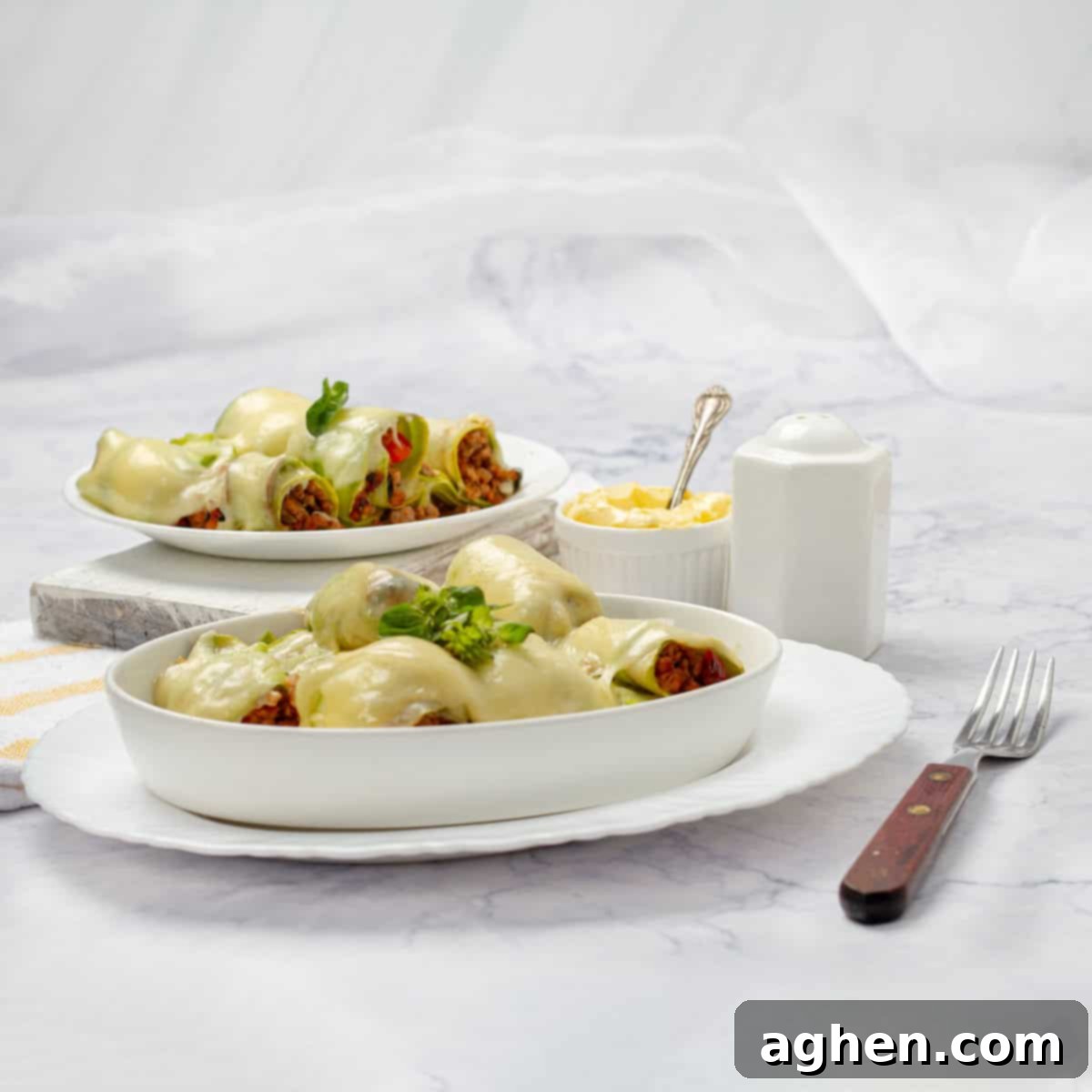 Freshly baked Zucchini Cannelloni, served in two plates and garnished, ready to be enjoyed.