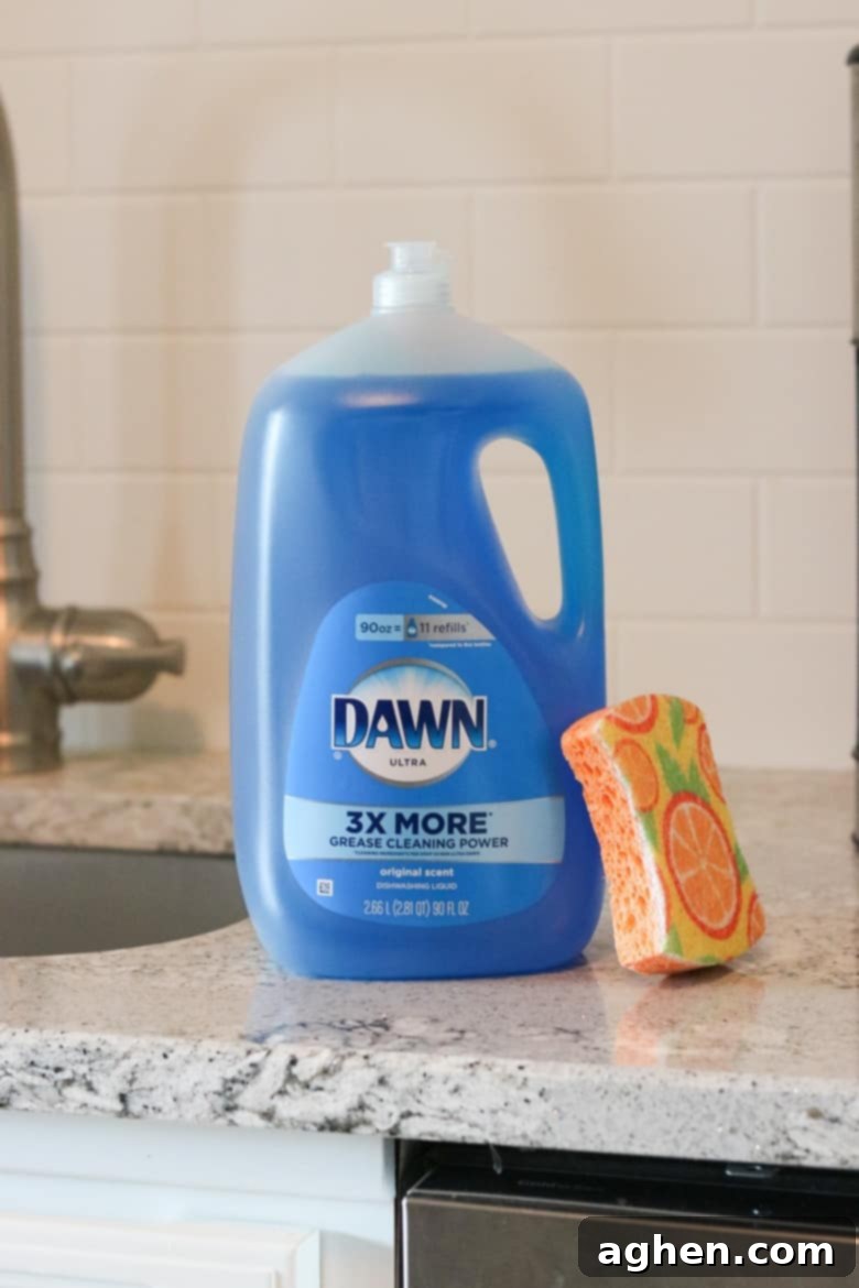 Dawn Ultra dish soap and orange sponge on a clean kitchen countertop, highlighting its versatility beyond dishwashing
