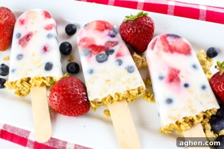 These easy yogurt popsicles are packed with fresh berries and granola, making them a tasty frozen breakfast to enjoy on-the-go on busy mornings.