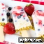 These easy yogurt popsicles are packed with fresh berries and granola, making them a tasty frozen breakfast to enjoy on-the-go on busy mornings.