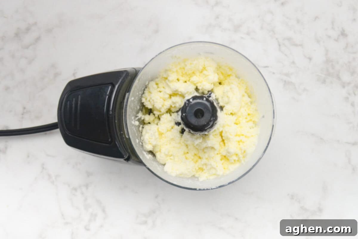 Party-Perfect Weight Watchers Whipped Feta Dip 4 A small food processor shows the texture after the initial blend of feta.