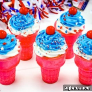 A festive 4th of July ice cream cone cupcake, topped with white and blue icing and patriotic sprinkles.