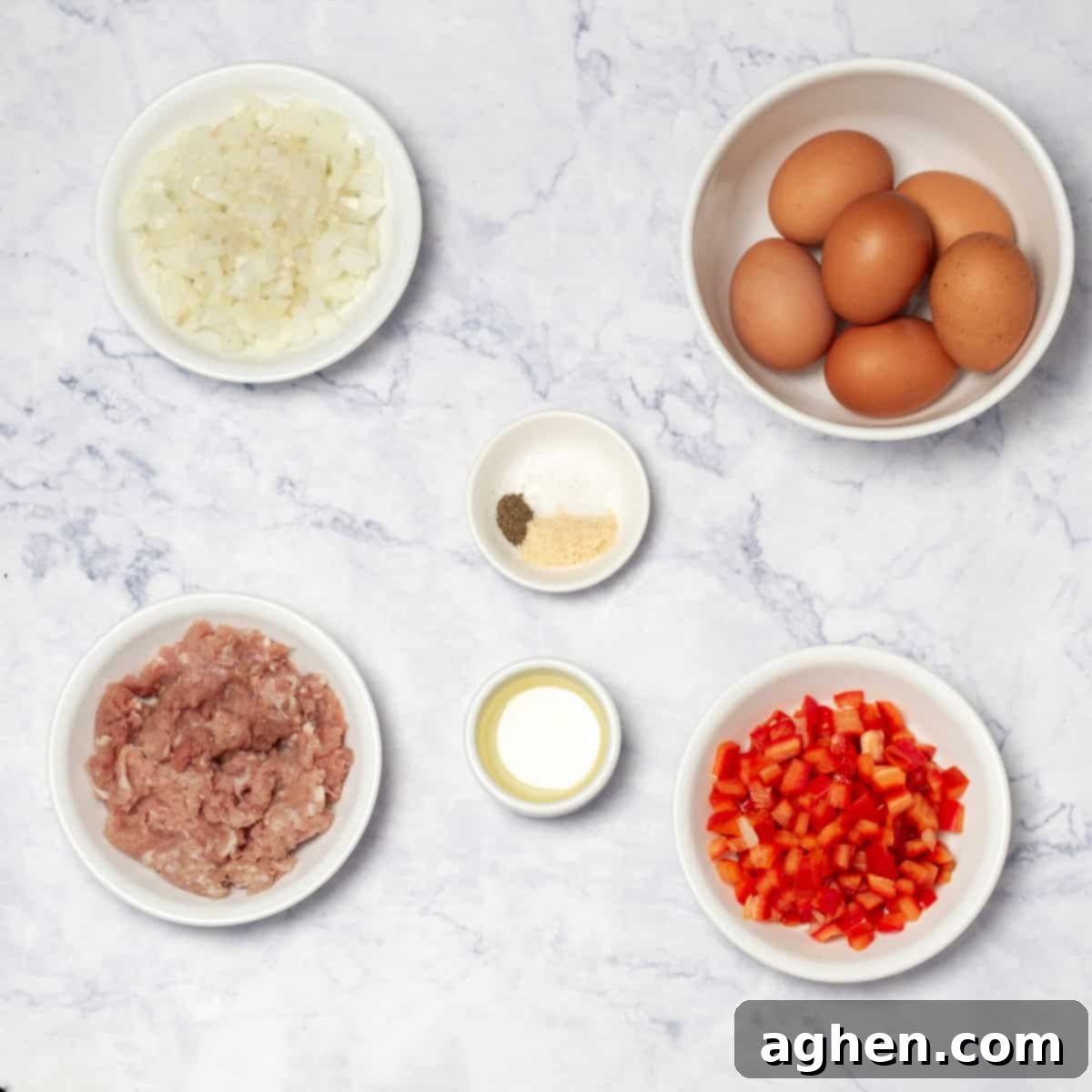 Weight Watchers Pork Egg Bites: Effortless On-the-Go Breakfast Solution 3 All the fresh ingredients for making Pork Egg Cups: olive oil, chopped onion, chopped red bell pepper, salt, pepper, garlic powder, lean ground pork, large eggs, and optional shredded cheddar cheese.