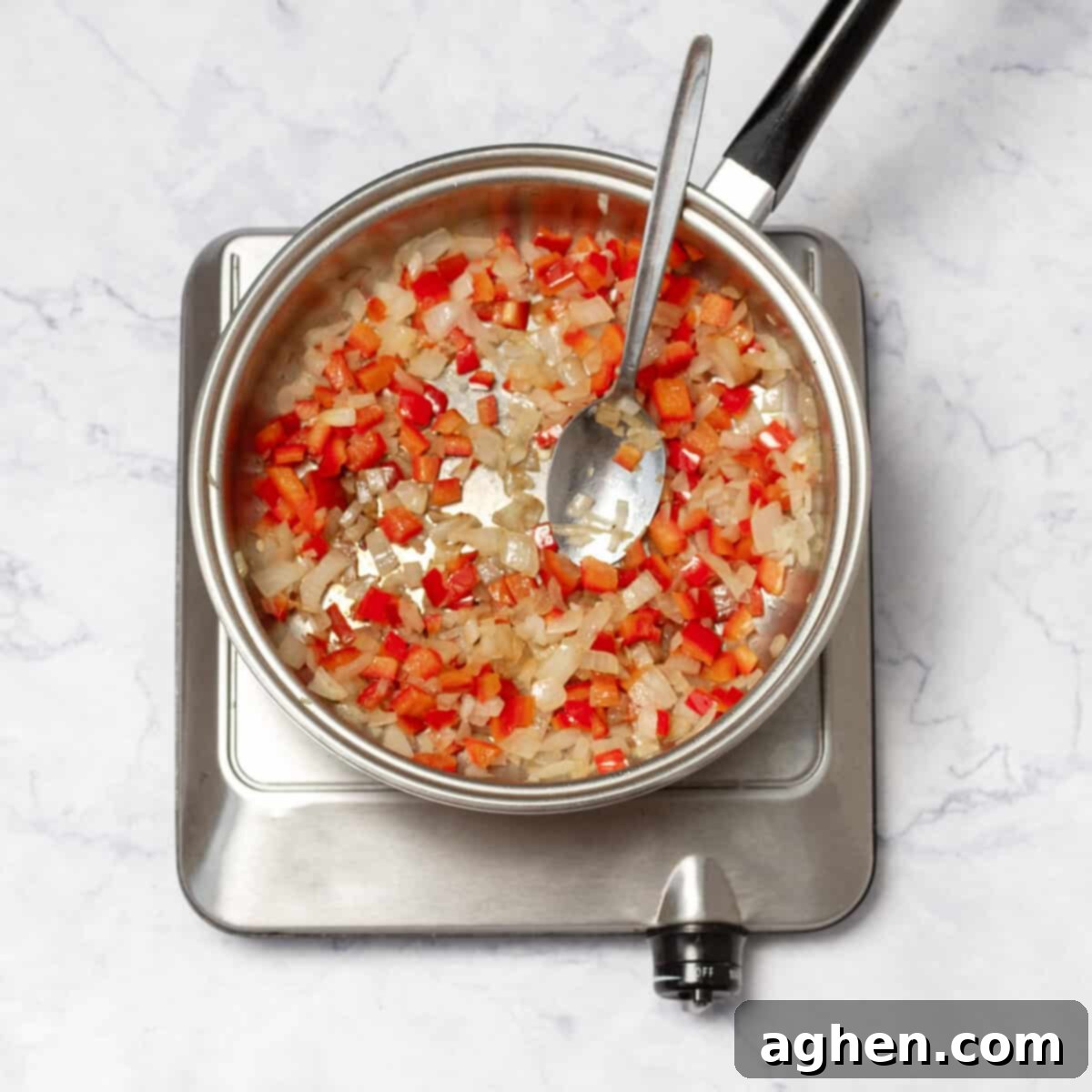 Weight Watchers Pork Egg Bites: Effortless On-the-Go Breakfast Solution 4 Finely diced onion and red bell pepper sizzling in olive oil in a skillet, softening beautifully.