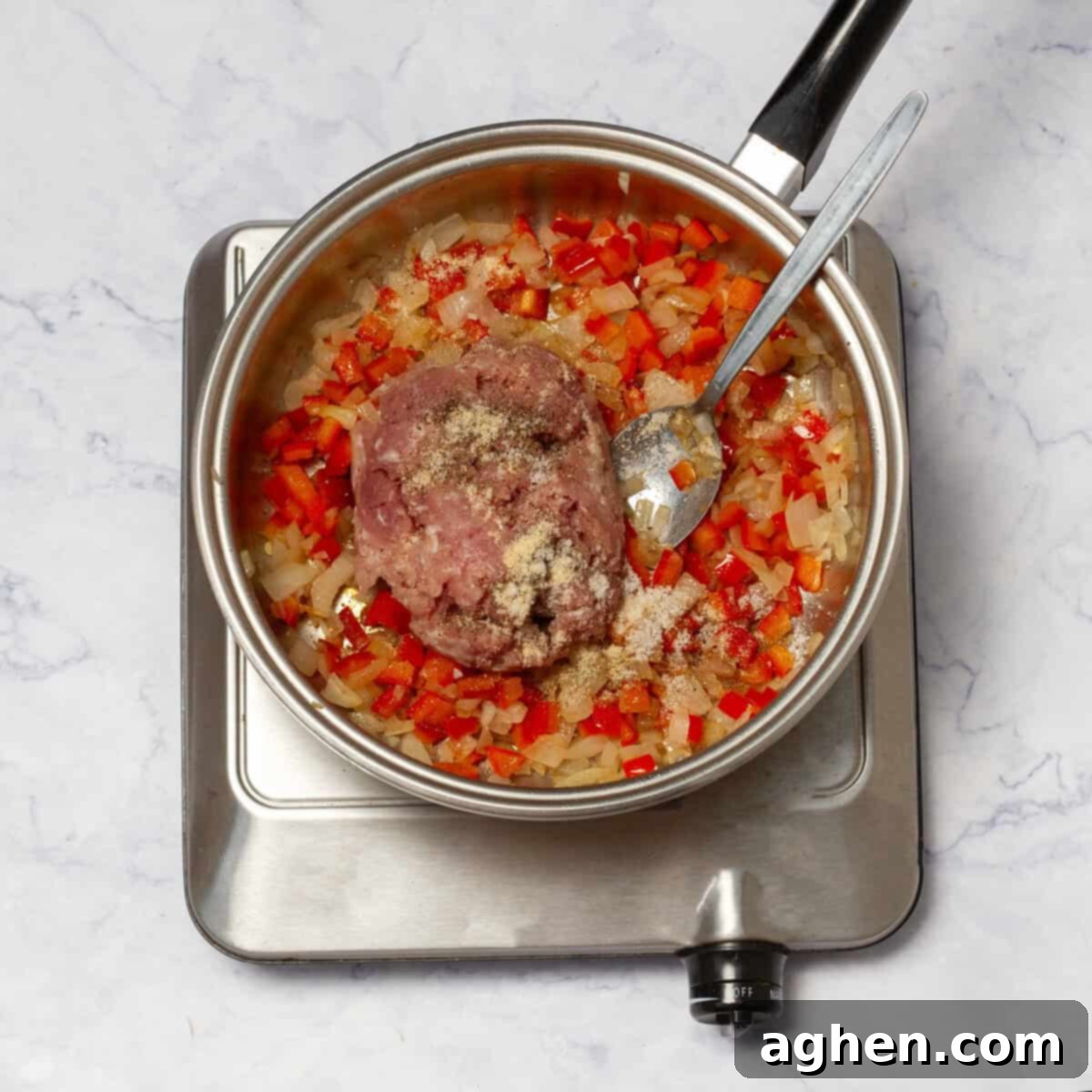 Weight Watchers Pork Egg Bites: Effortless On-the-Go Breakfast Solution 5 Lean ground pork being added to the skillet with the cooked vegetables and broken apart with a spatula until browned.