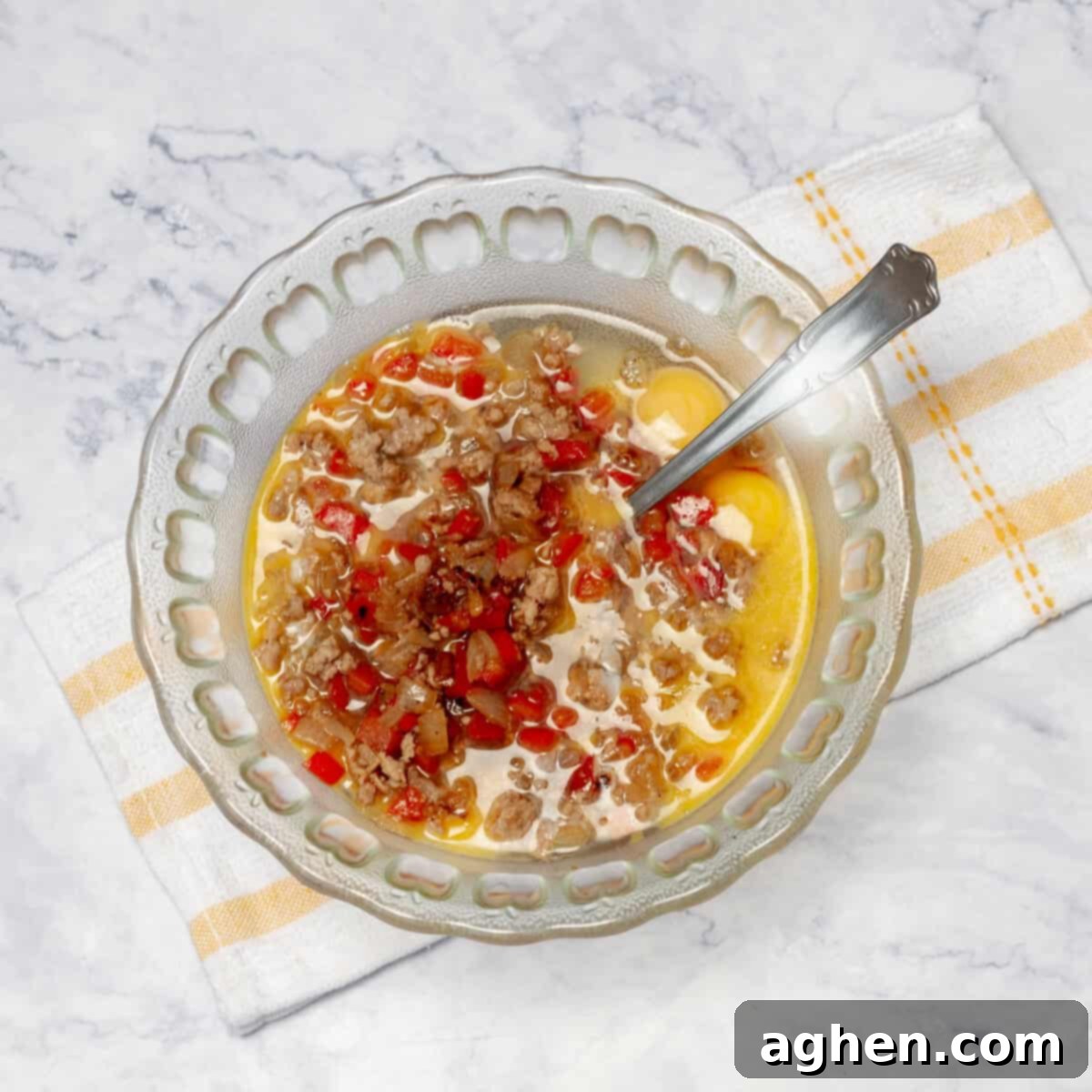 Weight Watchers Pork Egg Bites: Effortless On-the-Go Breakfast Solution 6 The savory pork and vegetable mixture being transferred into a bowl with lightly beaten eggs, ready for mixing.