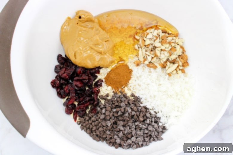 All no-bake energy ball ingredients in a large mixing bowl, ready to be combined.