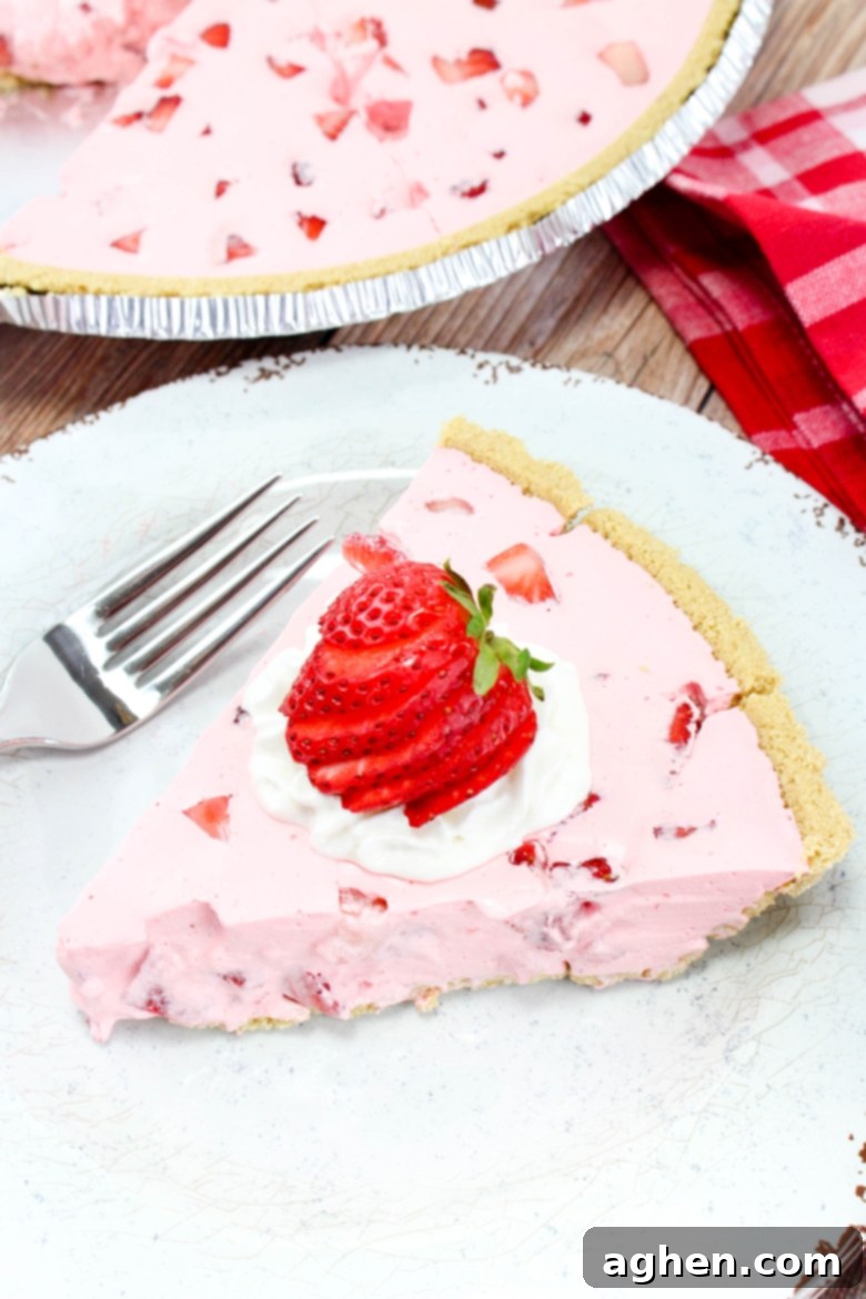 Effortless Strawberry Gem Pie 2 Pink Jello Pie with chunks of fresh strawberries and a graham cracker crust.
