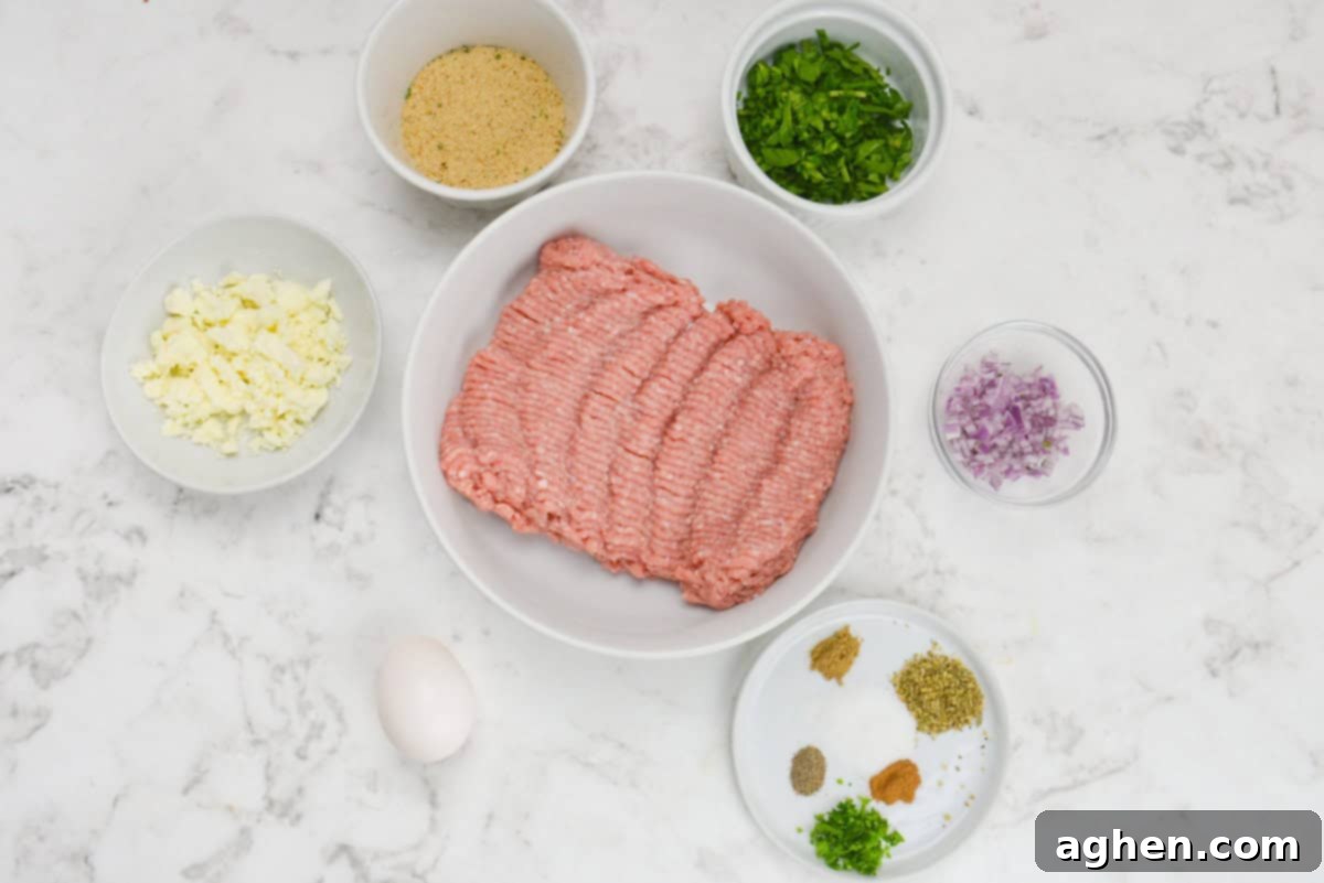 Zesty Greek Turkey Meatballs 3 The ingredients needed to make the recipe shown in various sized white and clear prep bowls