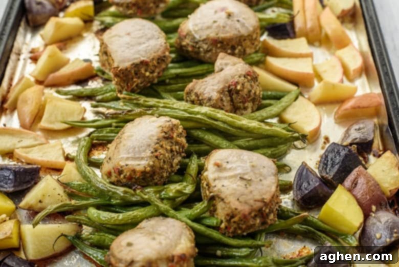 Potatoes, green beans, apples, and pork tenderloin medallions on sheet pan