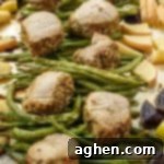 Potatoes, green beans, apples, and pork tenderloin medallions on sheet pan