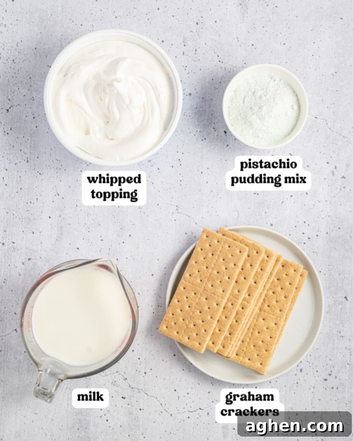 Labeled ingredients for pistachio icebox cake, including whipped topping, pistachio pudding mix, milk, and graham crackers.