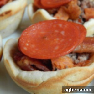 Two golden-brown mini deep dish pizzas, fresh from the oven, showcasing a crispy crust and melted toppings