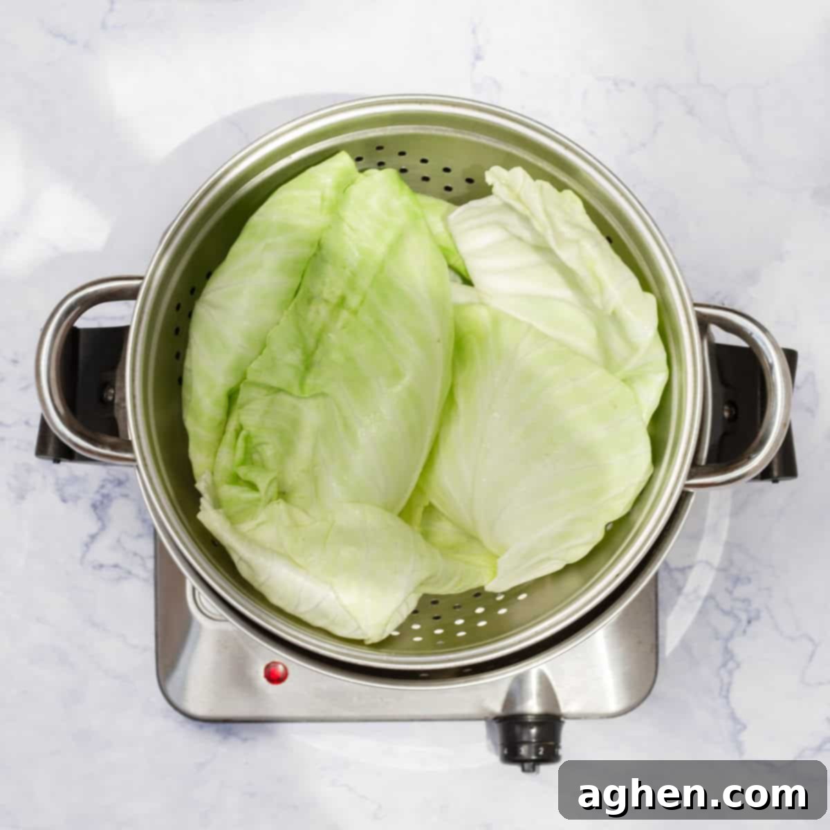 Freshly prepared cabbage leaves steaming gently in a large pot, transitioning from firm to beautifully soft and pliable, ready for the next stage of the recipe.