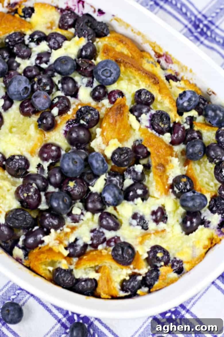 A beautiful blueberry breakfast casserole presented in an elegant white baking dish, its golden-brown top hinting at the deliciousness within, ready to be served and enjoyed by family and friends.