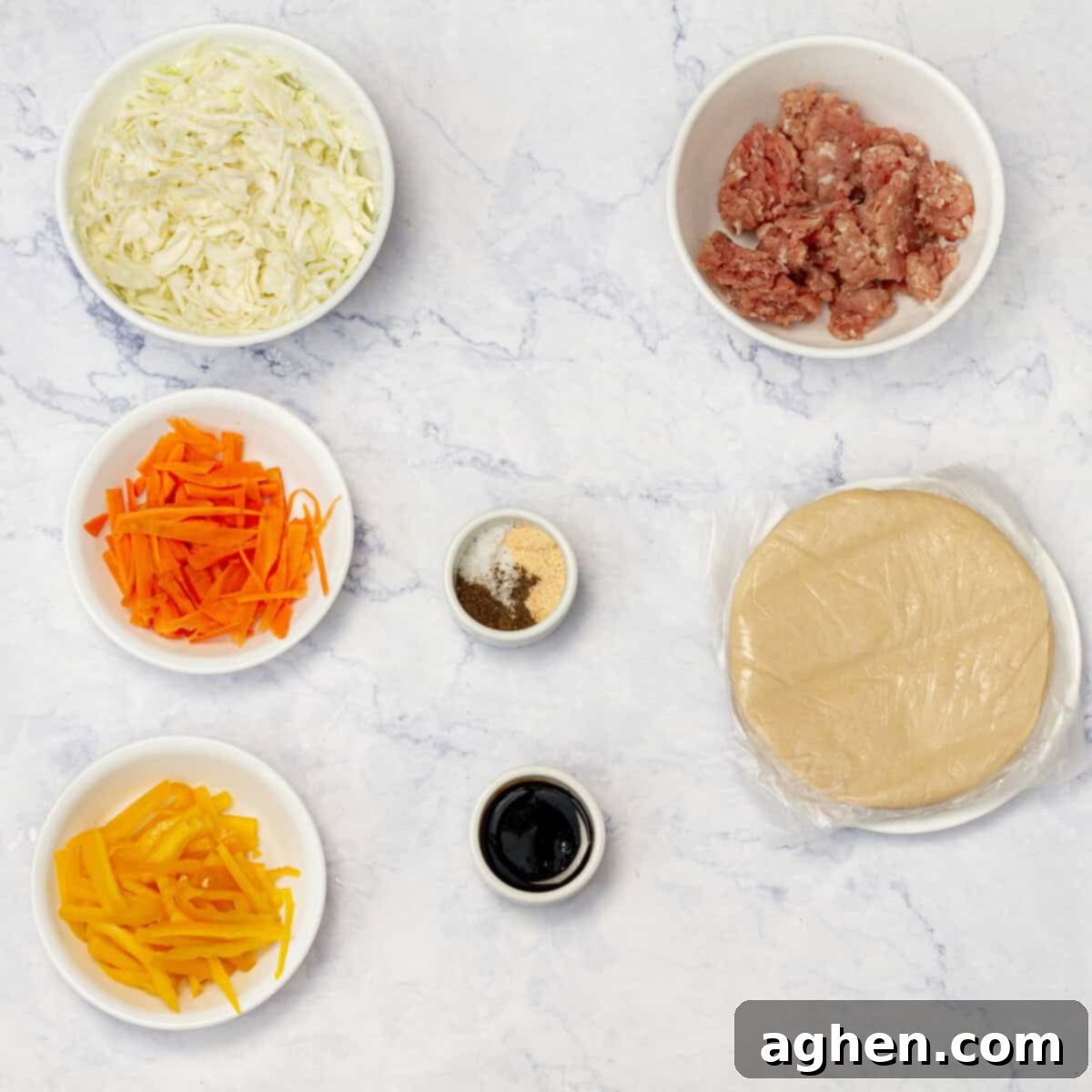 Ditch Takeout for These Weight Watchers Pork Egg Rolls 3 A selection of fresh ingredients for Air Fryer Pork Egg Rolls, including ground pork, various spices, sliced bell pepper, carrots, and cabbage, arranged neatly on a wooden surface.