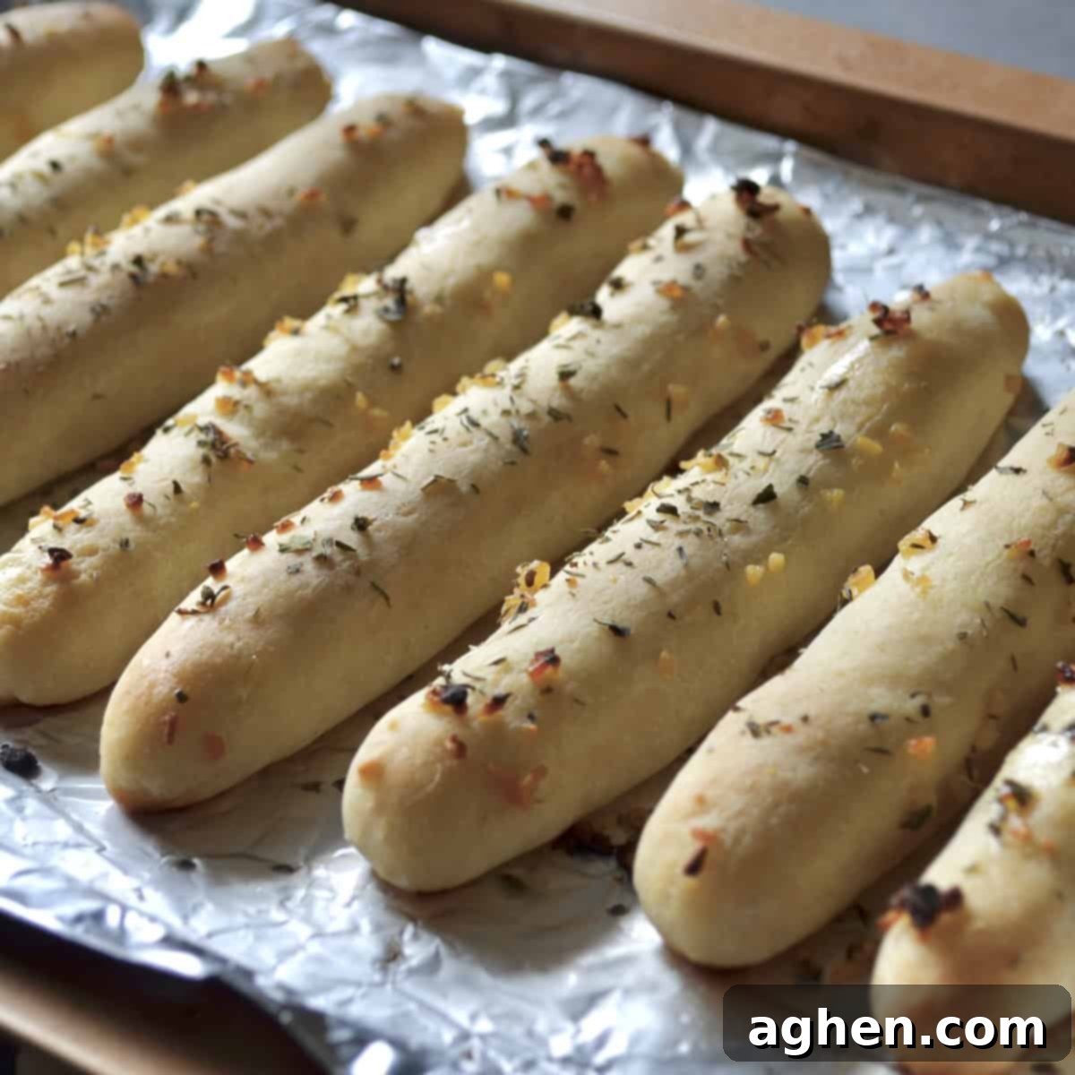 Baked golden brown bread sticks, fresh out of the oven, ready to be served