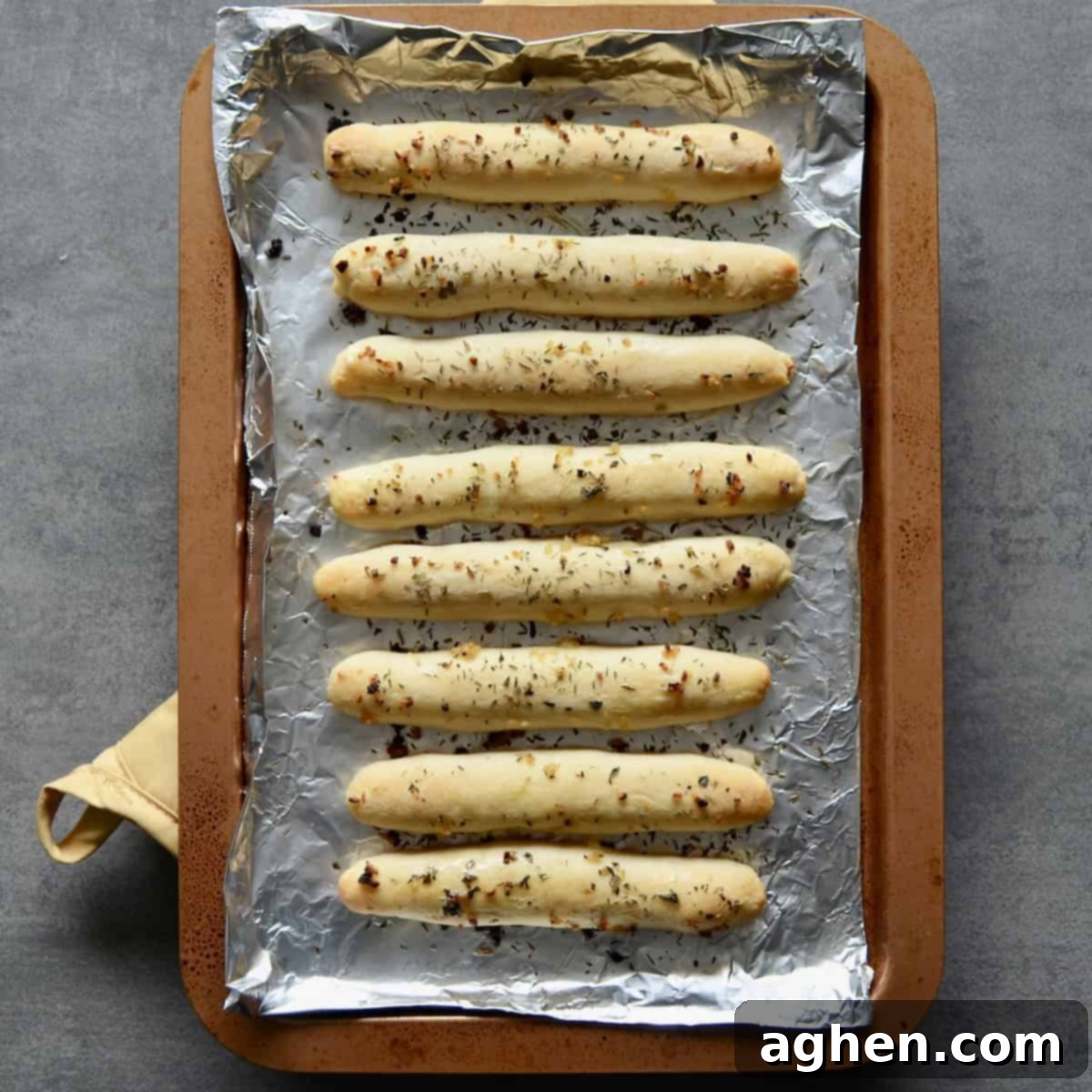Freshly baked Weight Watchers garlic breadsticks on a baking sheet