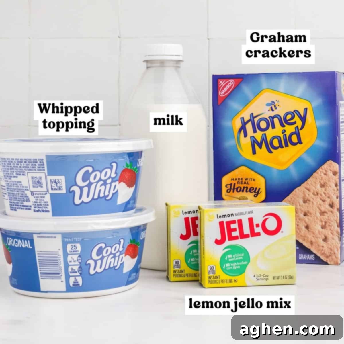 Two tubs of Cool Whip whipped topping, two boxes of lemon instant Jello mix, Honey maid graham crackers, and milk.
