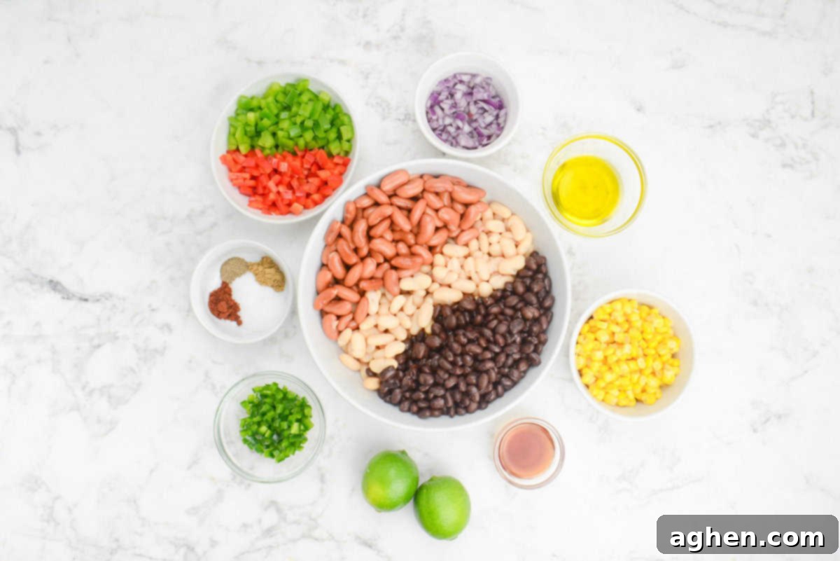 A large white bowl is filled with beans. Surrounding it are the ingredients to make the recipe in various sized bowls. 