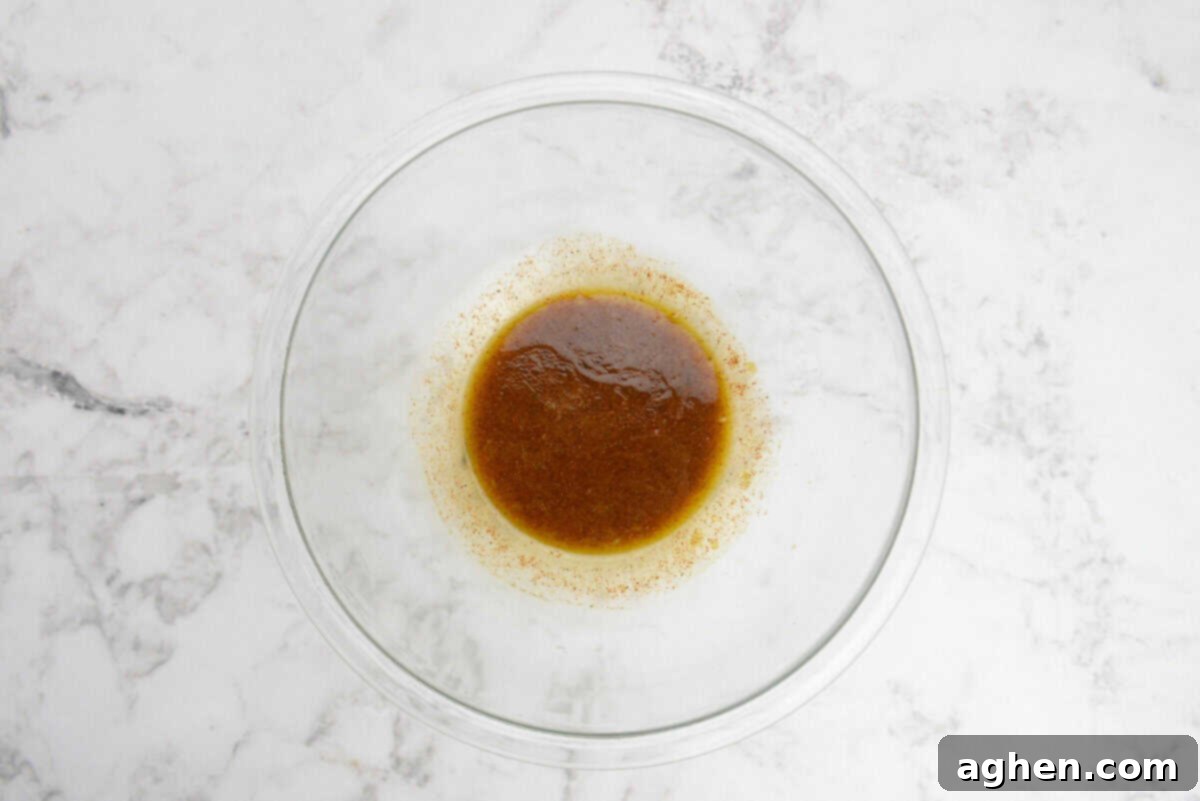 A large bowl with a small amount of the brown olive oil and spice mixture 