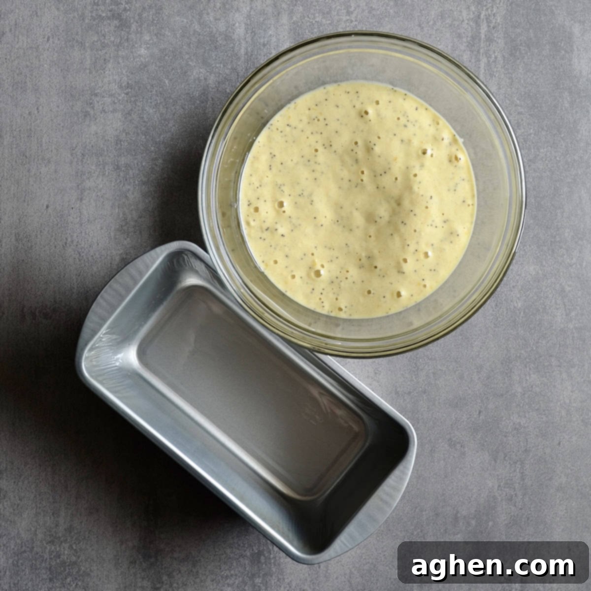 Weight Watchers Lemon Poppy Seed Loaf: A Slice of Pure Joy 4 Lemon poppy seed loaf batter in a greased loaf pan, ready to be placed in the oven for baking.