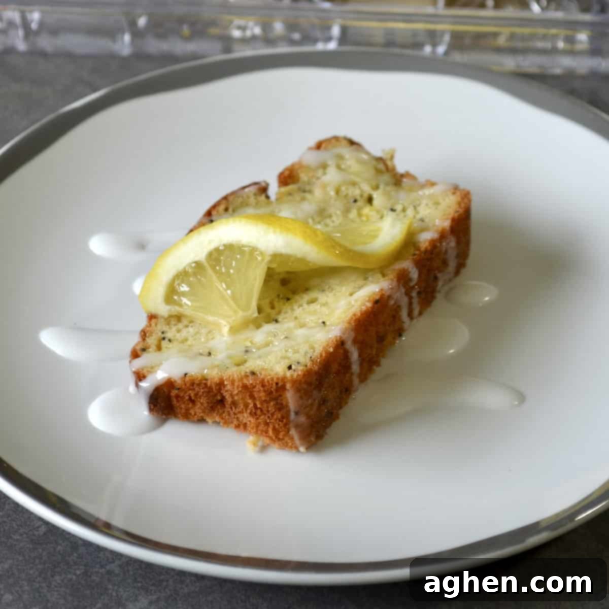 Weight Watchers Lemon Poppy Seed Loaf: A Slice of Pure Joy 5 A perfectly sliced piece of Weight Watchers lemon poppy seed bread with a bright glaze and a fresh lemon garnish.