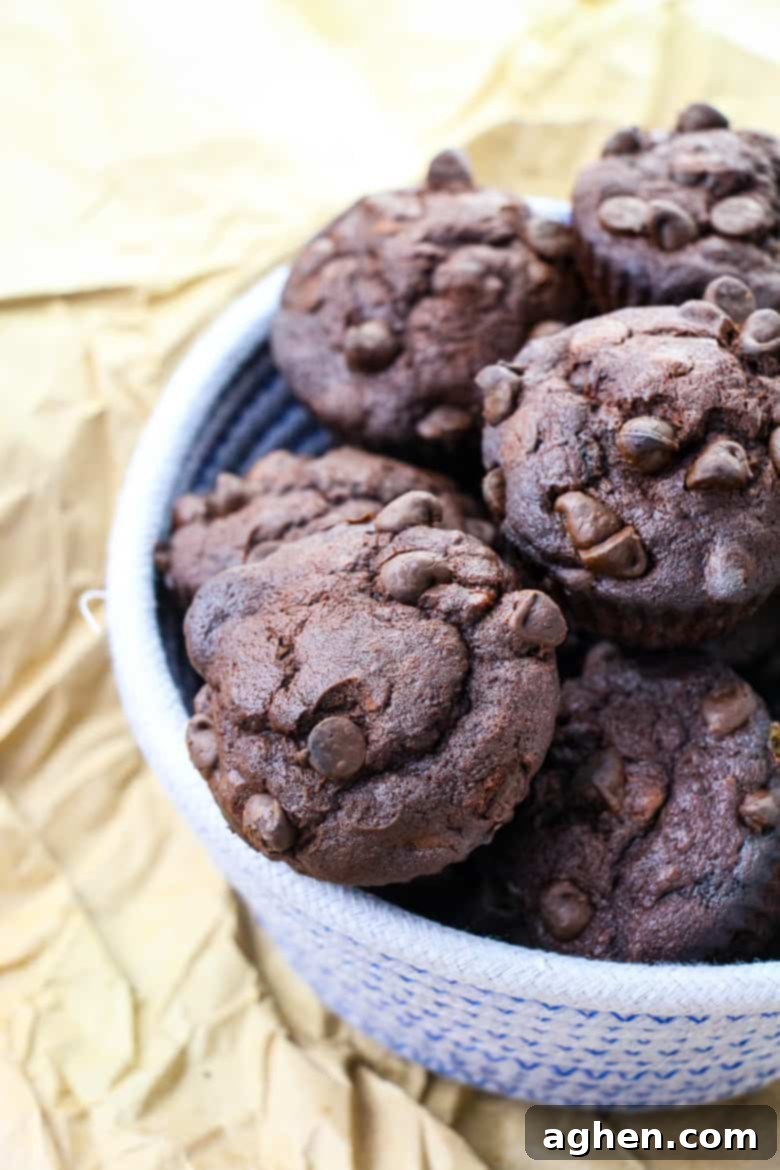 Ultimate Double Chocolate Banana Muffins 2 Double chocolate banana muffins in woven bowl.