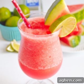 Frozen Watermelon Margarita garnished with watermelon slice and lime slice