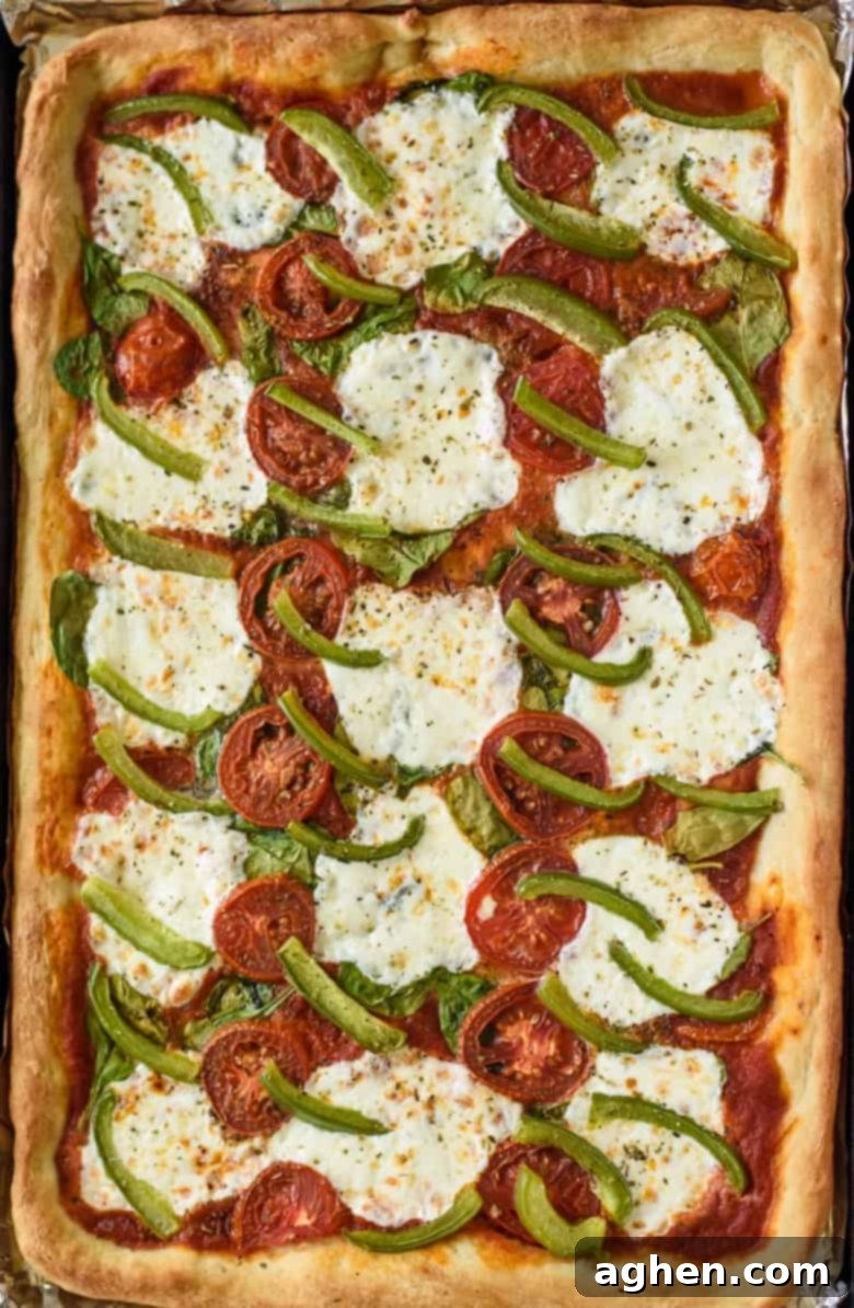 One-Pan Wonder Pizza 3 Sheet Pan Pizza with spinach, mozzarella, and peppers.