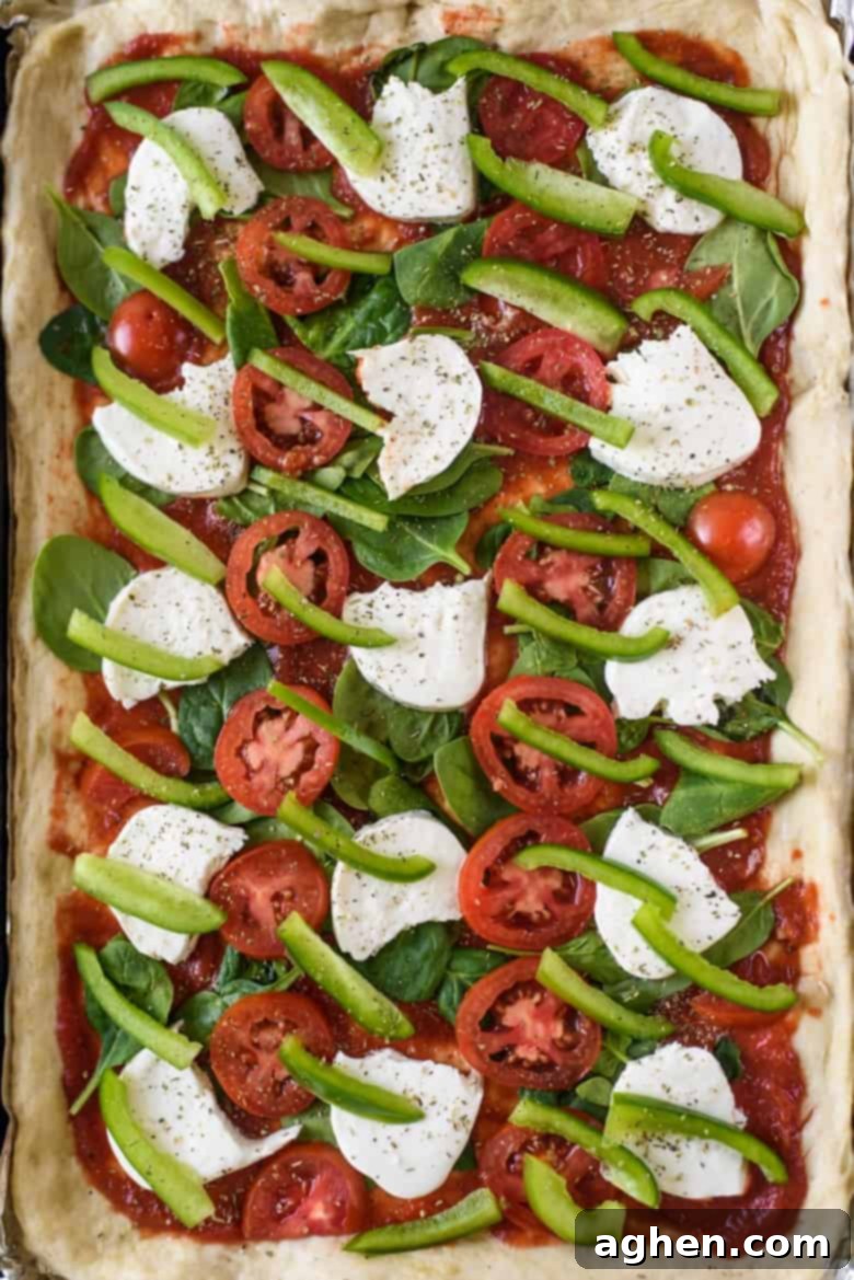 One-Pan Wonder Pizza 5 Pizza on a lined sheet pan before going in the oven.