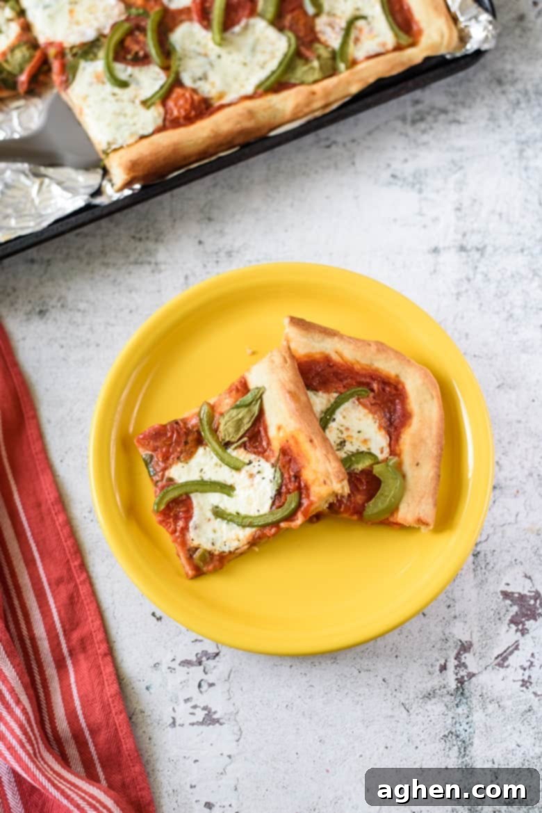One-Pan Wonder Pizza 6 Slices of Sheet Pan Pizza on yellow plate.