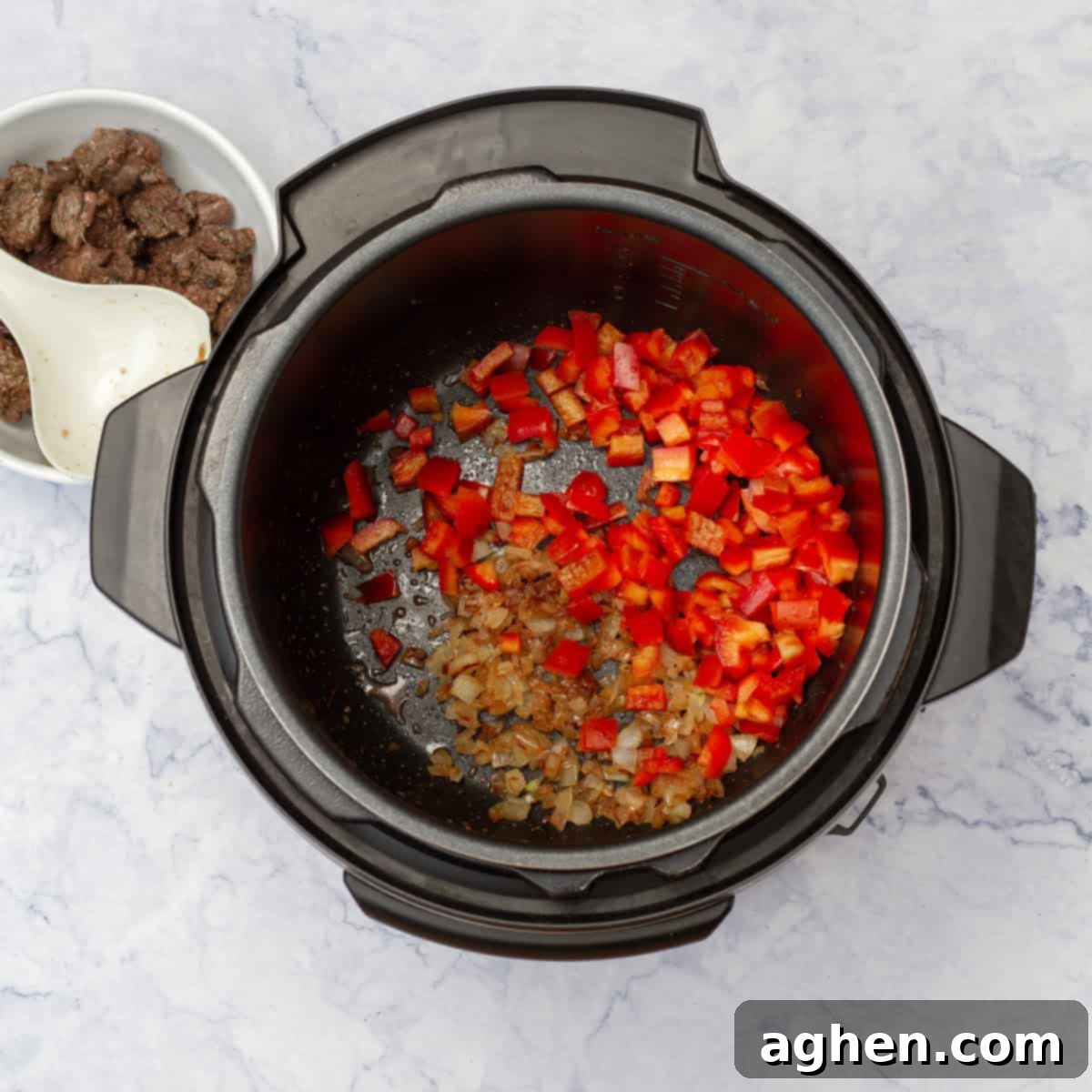 In the instant pot, add the diced onion and garlic