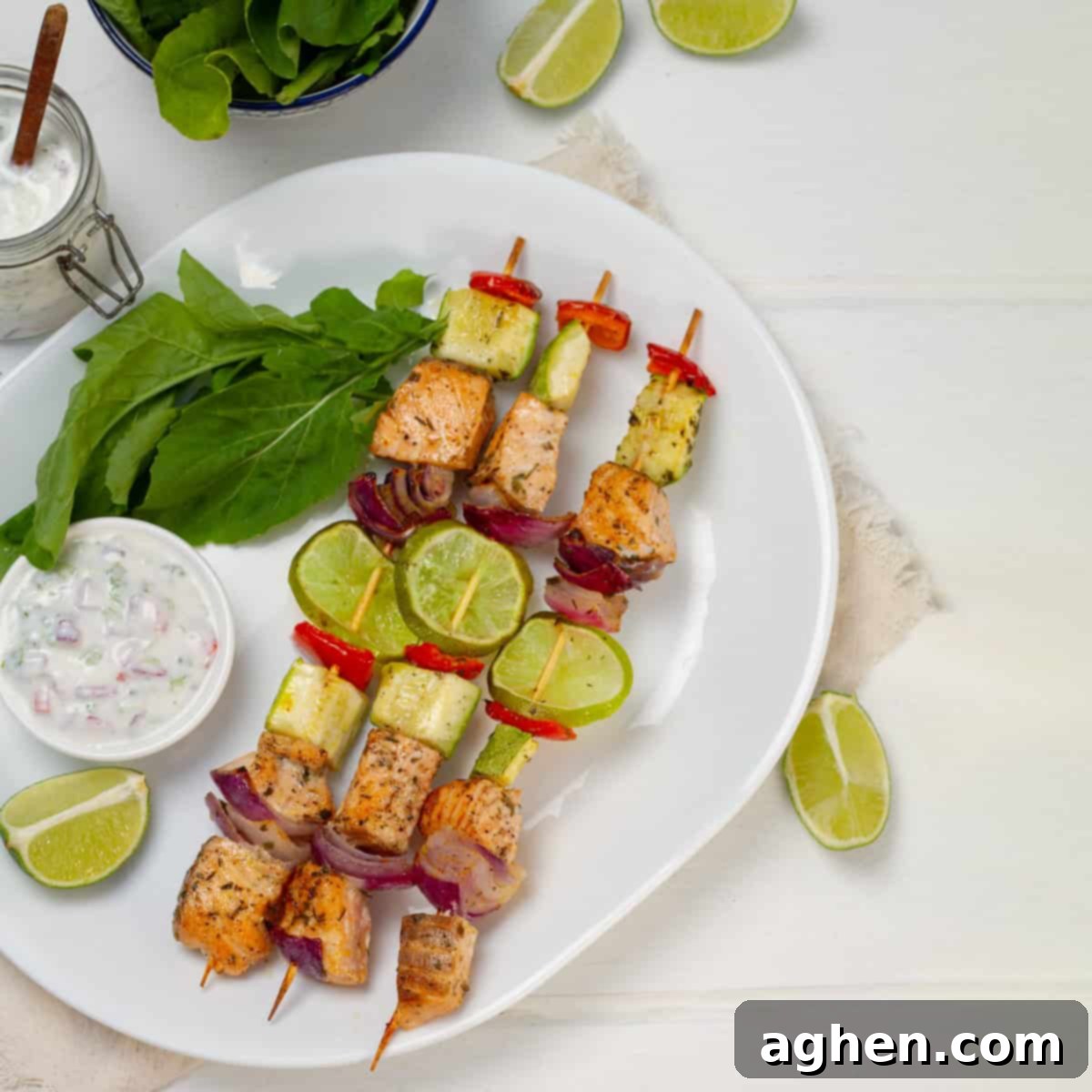 Zesty Herb Salmon Skewers 2 Salmon Skewers served with lemons and greens, ready to eat