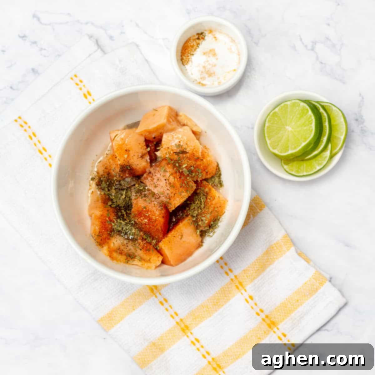 Zesty Herb Salmon Skewers 4 Salmon cubes marinating in a bowl with spices and lime juice