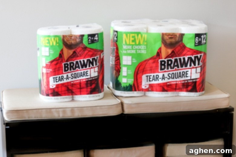 Brawny® Tear-A-Square® paper towels resting on a wooden bench, ready for use.
