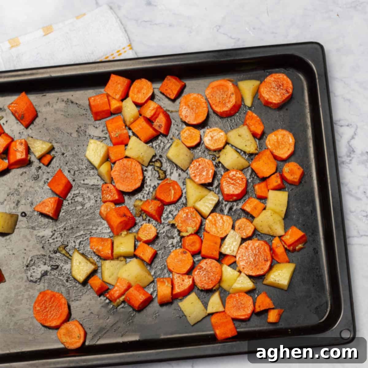 Velvety Roasted Carrot Soup 5 carrots and potato cubes spread in backing tray